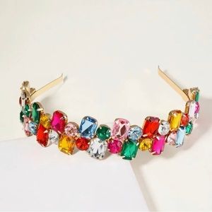 New headband with gold trimming base and colored gems.